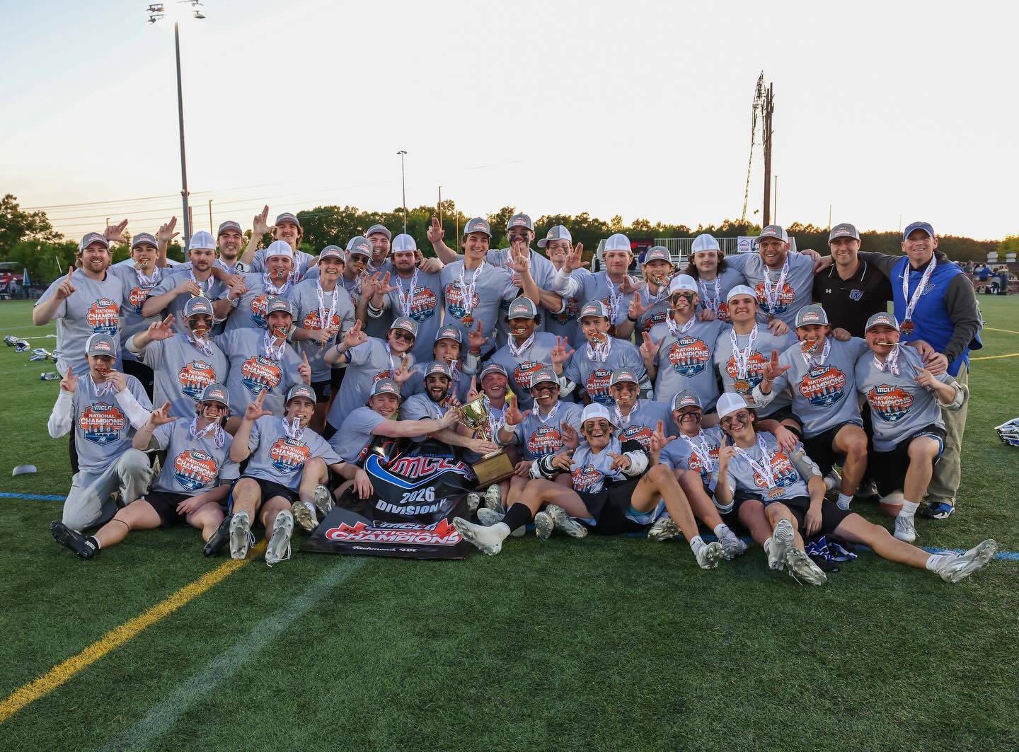 Men's Lacrosse team on field after win